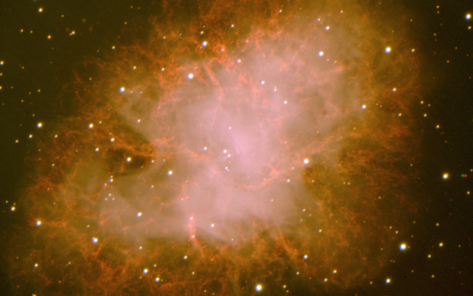 The Crab Nebula (Messier 1), as observed by VIMOS. This well-known object is the remnant of a stellar explosion in the year 1054. The image is a composite VRI image obtained on March 4, 2002. The individual exposures lasted 180 seconds; image quality 0.7 arcsec FWHM; field 7 x 7 arcmin2; North is up and East is left.