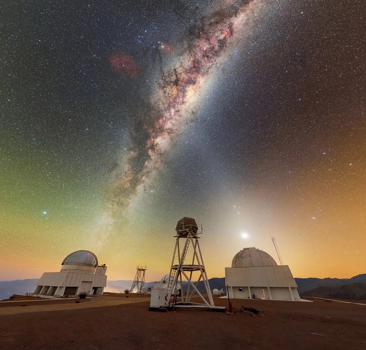 Celestial beams of light formed from both the Milky Way and zodiacal light crisscross above the telescopes of the U.S. National Science Foundation Cerro Tololo Inter-American Observatory (CTIO), a Program of NSF NOIRLab. The US Naval Observatory Deep South Telescope sits on the far left of this image. Moving towards the right, there is also the DIMM1 Seeing Monitor, the CHilean Automatic Supernova sEarch dome (CHASE), the UBC Southern Observatory, and the Planetary Defense 1.0-meter Telescope. These represent only a subset of the nearly 40 telescopes at CTIO, so this celestial X truly marks the spot of a treasure trove of discovery! Many of the telescopes pictured here have specialized purposes on behalf of their sponsors. For example, the UBC Southern Observatory 0.35-meter (1.15-foot) telescope was made specifically for the site-testing campaign of the Thirty Meter Telescope. Today, it is used by the University of British Columbia in Canada for research on transiting exoplanets and space debris. Another specialized telescope at CTIO is the Planetary Defense 1.0-meter Telescope, operated by the University of North Carolina and the Astronomical Research Institute. This telescope conducts southern-sky astrometric follow-up observations of Near-Earth Asteroids (NEAs). This photo was taken as part of the NOIRLab 2022 Photo Expedition to all the NOIRLab sites. Petr Horálek, the photographer, is a NOIRLab Audiovisual Ambassador.